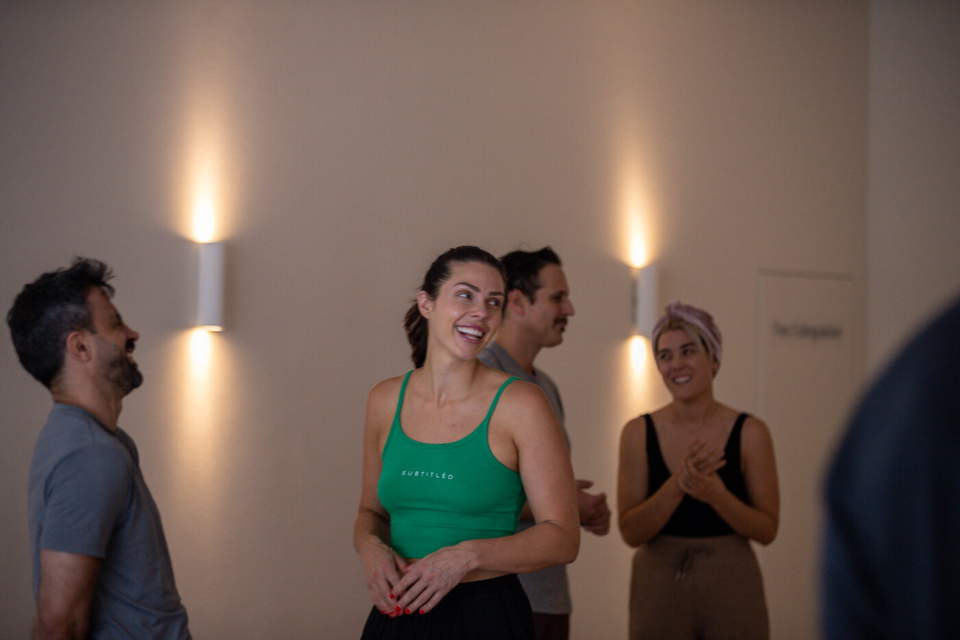 Participants sitting in a circle from above, each with cushions and props, beginning a breathwork session with Daniel Augustine.