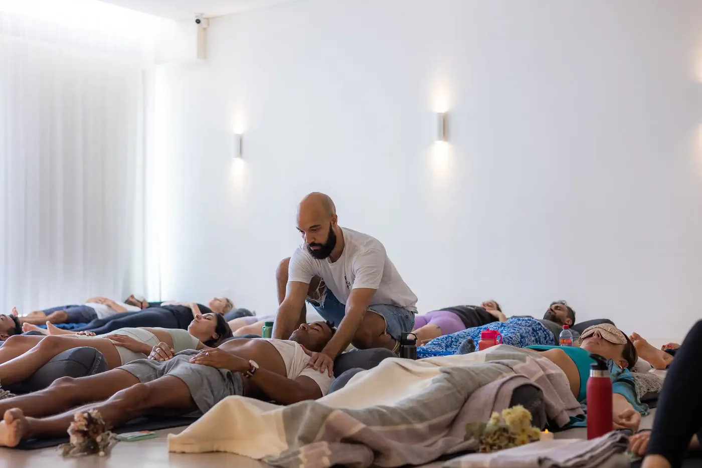 People lying on mats during a group breathwork session